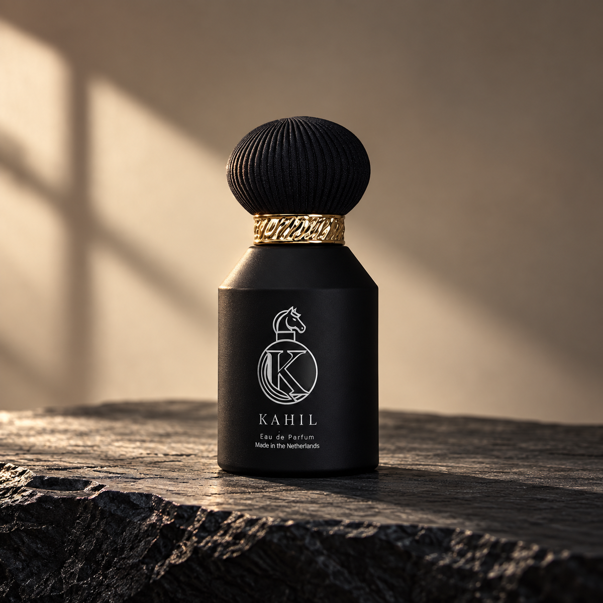 Kahil Extrait de Parfum, schwarze Flasche mit goldenem Ring auf dunklem Stein